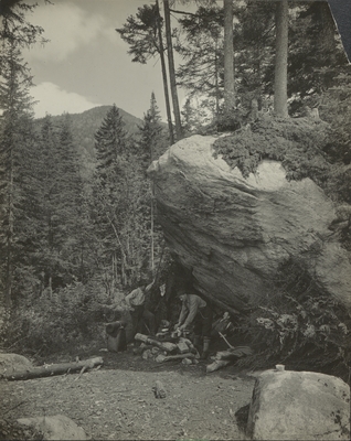 Three men making camp at Slant Rock on the Johns Brook trail up Mount Marcy, NY, June 1920.